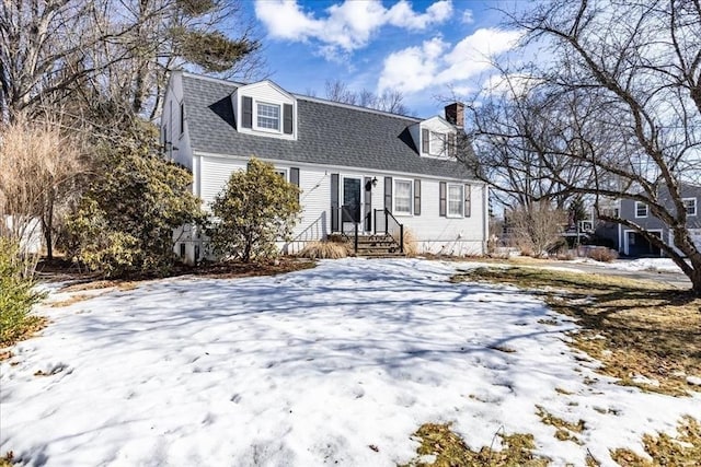 colonial inspired home with roof with shingles and a gambrel roof