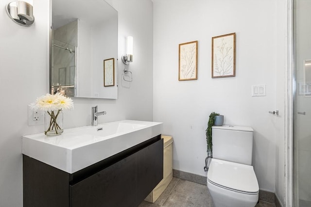 full bathroom with baseboards, toilet, vanity, and a shower