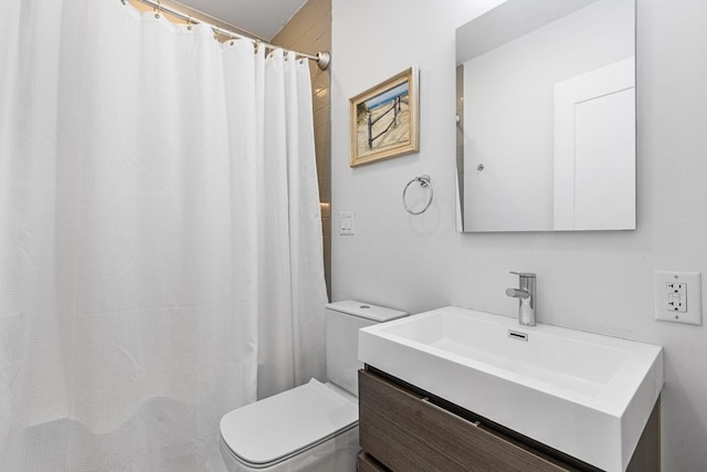 bathroom featuring toilet, vanity, and a shower with shower curtain