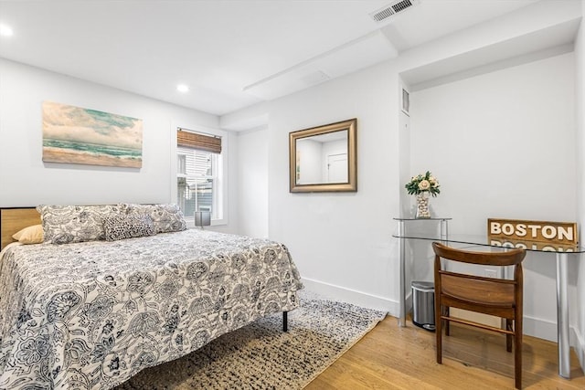 bedroom featuring wood finished floors, recessed lighting, and baseboards