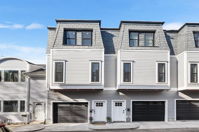 view of property featuring a garage and driveway