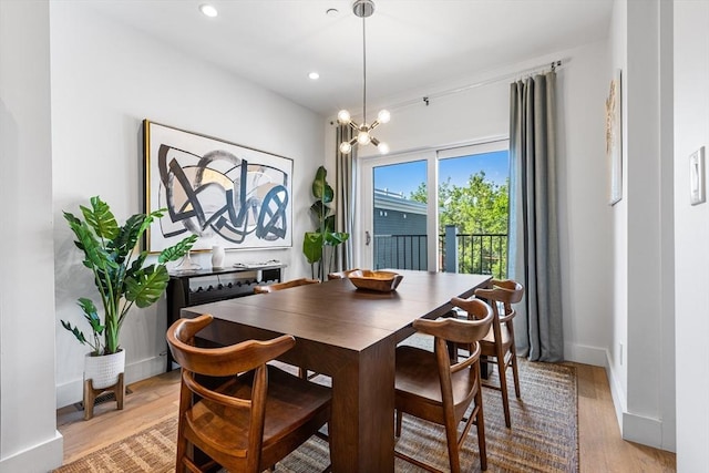 dining area featuring light wood finished floors, a chandelier, recessed lighting, and baseboards