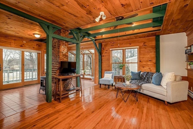 living room featuring light hardwood / wood-style floors and wooden walls