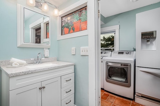 bathroom featuring vanity and independent washer and dryer