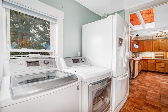 laundry room featuring washing machine and clothes dryer