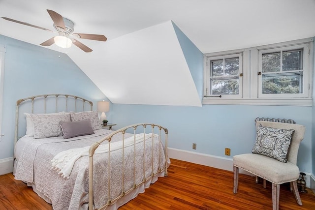 bedroom with vaulted ceiling, ceiling fan, and hardwood / wood-style flooring