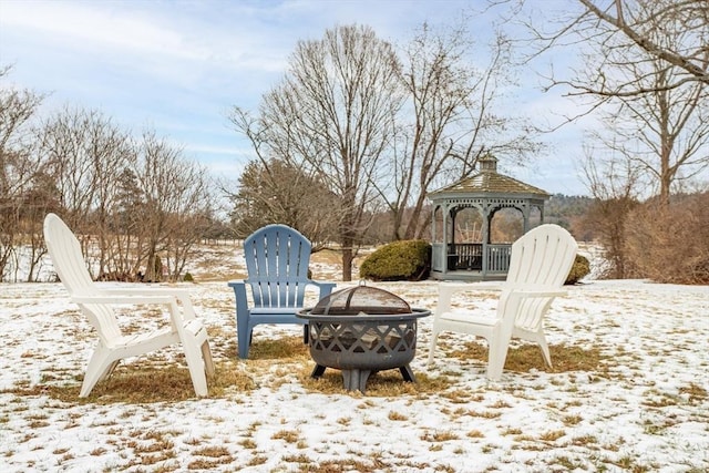 snowy yard with a gazebo and a fire pit