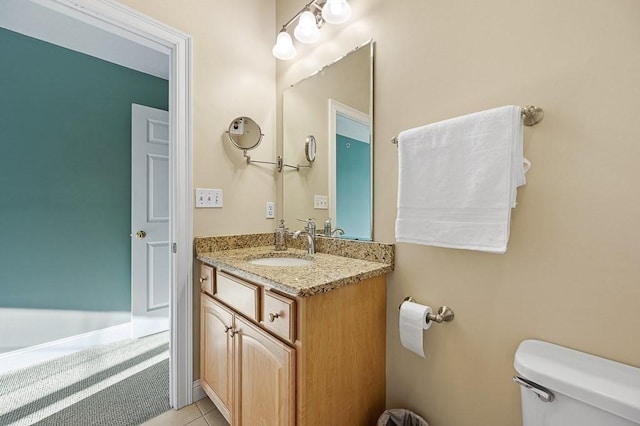 bathroom with vanity, tile patterned floors, and toilet