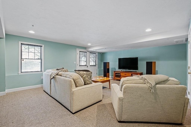 living room with a healthy amount of sunlight and light colored carpet