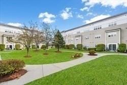 211 Central Unit A210, Norwood, MA 02062 - view of community featuring a lawn