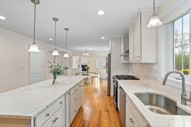211 Central Unit A210, Norwood, MA 02062 - kitchen featuring stainless steel appliances, a sink, a center island, recessed lighting, and light wood-style floors