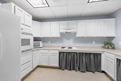 211 Central Unit A210, Norwood, MA 02062 - kitchen with white appliances, white cabinets, and light countertops