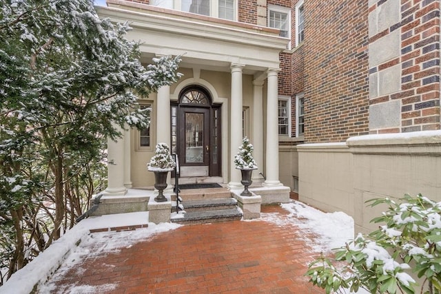 view of snow covered property entrance