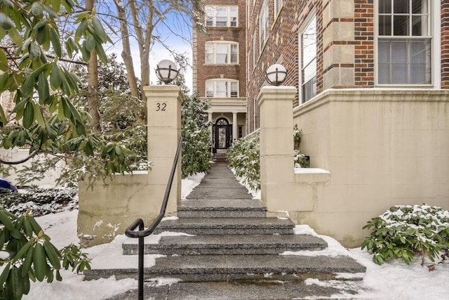 view of snow covered property entrance