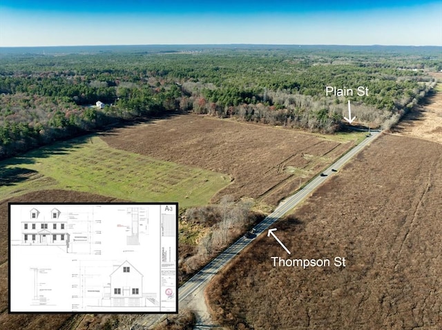 drone / aerial view featuring a view of trees