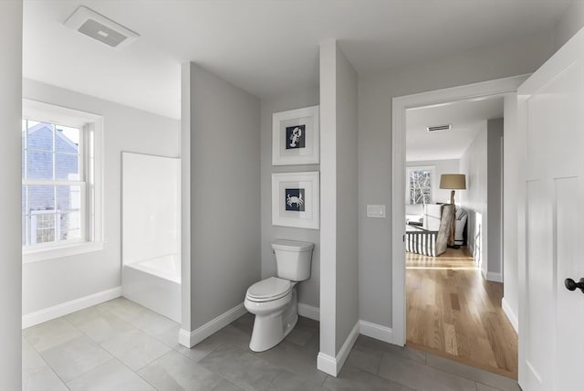 full bathroom featuring tile patterned floors, toilet, baseboards, and visible vents