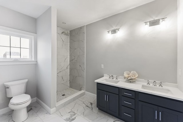 bathroom featuring a sink, toilet, and marble finish floor