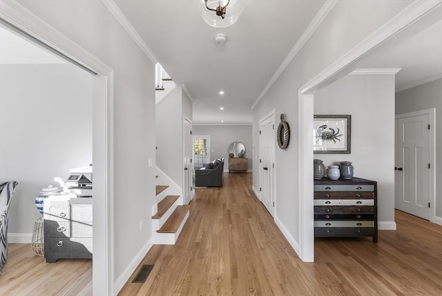 corridor featuring visible vents, stairs, crown molding, and wood finished floors
