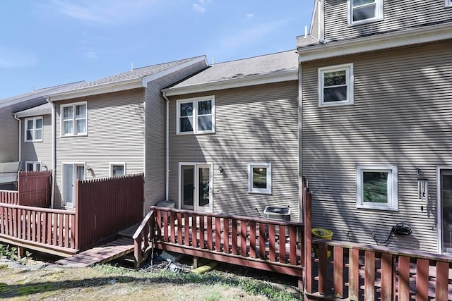 back of house featuring fence and a wooden deck