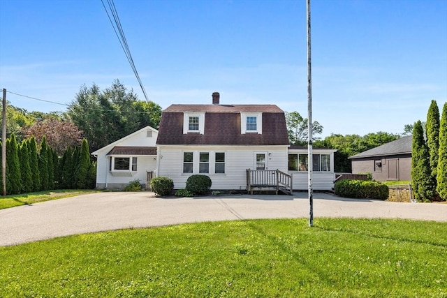 225 W Main St, Dudley, MA 01571 - view of front of property featuring a gambrel roof, a chimney, a shingled roof, and a front lawn