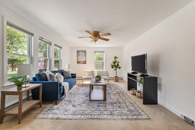 225 W Main St, Dudley, MA 01571 - living room featuring carpet flooring, a ceiling fan, a baseboard radiator, and a textured ceiling