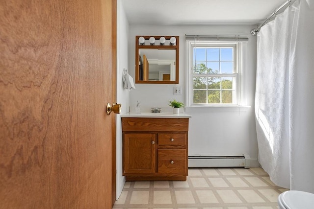 225 W Main St, Dudley, MA 01571 - full bathroom with baseboard heating, tile patterned floors, vanity, and a shower with shower curtain