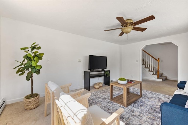 225 W Main St, Dudley, MA 01571 - living room with ceiling fan, light carpet, stairs, arched walkways, and baseboard heating