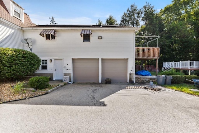 225 W Main St, Dudley, MA 01571 - view of front of house featuring asphalt driveway, a garage, and a wooden deck