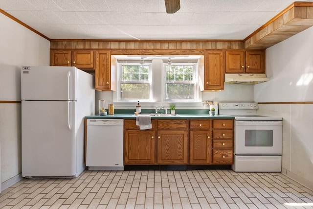 225 W Main St, Dudley, MA 01571 - kitchen featuring white appliances, under cabinet range hood, brown cabinetry, brick patterned flooring, and crown molding