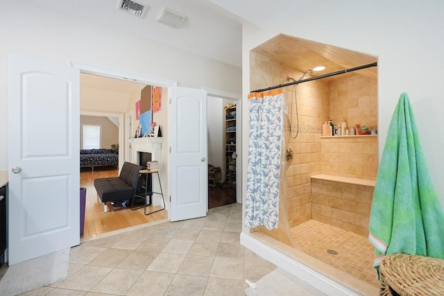 41 Webber St Unit 2, Malden, MA 02148 - bathroom with a shower stall, tile patterned floors, and a fireplace
