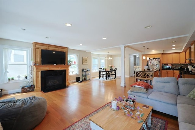 41 Webber St Unit 2, Malden, MA 02148 - living room featuring a fireplace, light wood finished floors, a chandelier, recessed lighting, and ornate columns