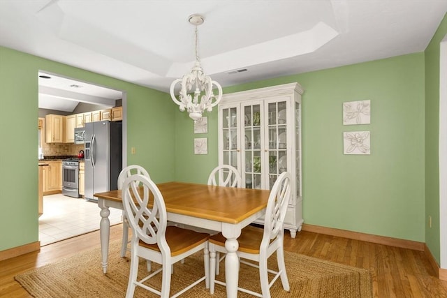 3 Dogwood Cir Unit 3, Franklin, MA 02038 - dining area featuring a chandelier, light wood-style flooring, baseboards, and a raised ceiling