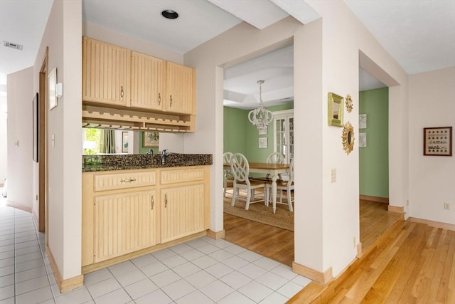 3 Dogwood Cir Unit 3, Franklin, MA 02038 - kitchen with light wood-type flooring, cream cabinets, a chandelier, baseboards, and dark stone counters