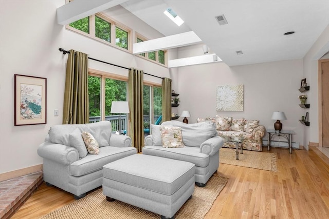 3 Dogwood Cir Unit 3, Franklin, MA 02038 - living room featuring wood finished floors, a high ceiling, baseboard heating, and baseboards
