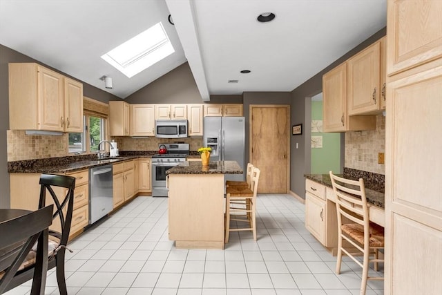 3 Dogwood Cir Unit 3, Franklin, MA 02038 - kitchen with appliances with stainless steel finishes, light brown cabinetry, a skylight, vaulted ceiling, and a kitchen breakfast bar