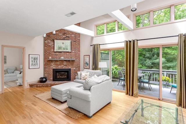 3 Dogwood Cir Unit 3, Franklin, MA 02038 - living room with wood finished floors, a brick fireplace, and high vaulted ceiling