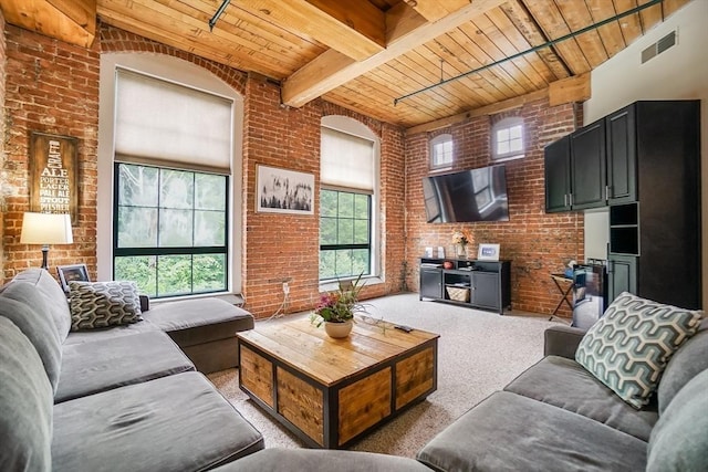 14 Sanford St Unit 21, Medway, MA 02053 - living room featuring wood ceiling with exposed beams, brick wall, and light carpet