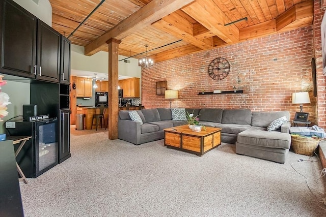 14 Sanford St Unit 21, Medway, MA 02053 - living room featuring wood ceiling with exposed beams, light colored carpet, brick wall, and ornate columns