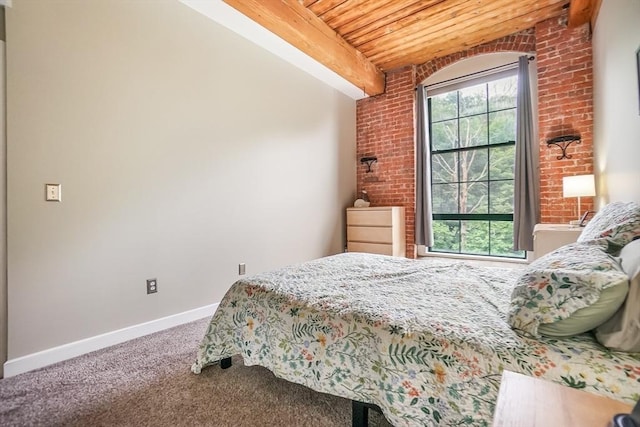 14 Sanford St Unit 21, Medway, MA 02053 - bedroom featuring wood ceiling with exposed beams, carpet flooring, brick wall, and baseboards