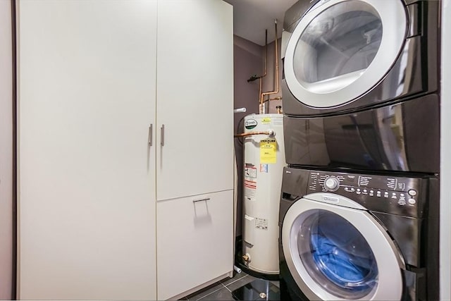 14 Sanford St Unit 21, Medway, MA 02053 - laundry area featuring stacked washer / dryer, water heater, and tile patterned flooring