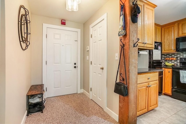 14 Sanford St Unit 21, Medway, MA 02053 - kitchen featuring black appliances, tasteful backsplash, dark countertops, and baseboards