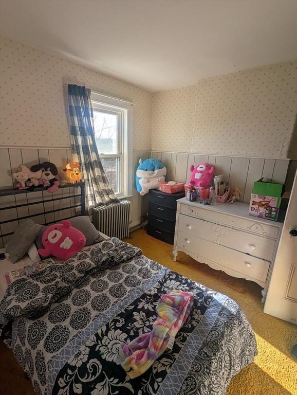 carpeted bedroom with radiator heating unit