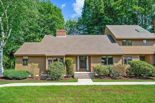 22 Grove Pl Unit 4, Winchester, MA 01890 - view of front of house featuring a chimney, a front yard, and roof with shingles
