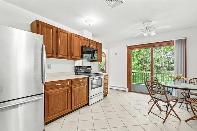 22 Grove Pl Unit 4, Winchester, MA 01890 - kitchen with appliances with stainless steel finishes, a baseboard radiator, light countertops, a ceiling fan, and brown cabinetry