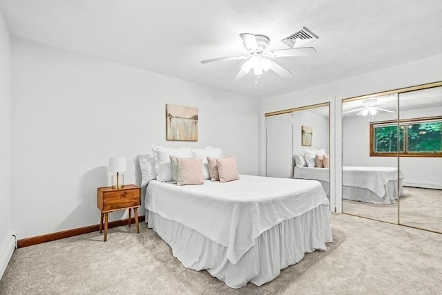 22 Grove Pl Unit 4, Winchester, MA 01890 - bedroom featuring light colored carpet, a ceiling fan, a baseboard radiator, baseboards, and two closets