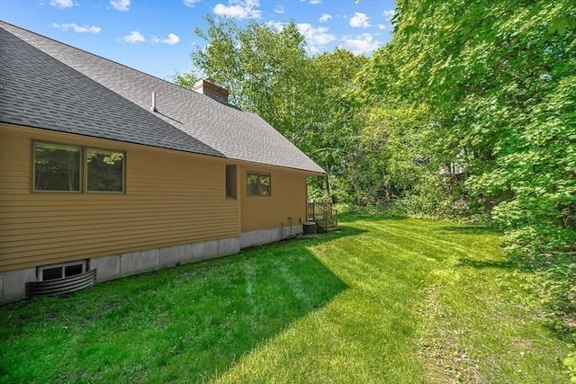 22 Grove Pl Unit 4, Winchester, MA 01890 - view of home's exterior featuring roof with shingles, a chimney, central AC unit, and a lawn