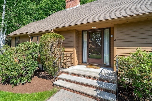 22 Grove Pl Unit 4, Winchester, MA 01890 - property entrance with roof with shingles and a chimney