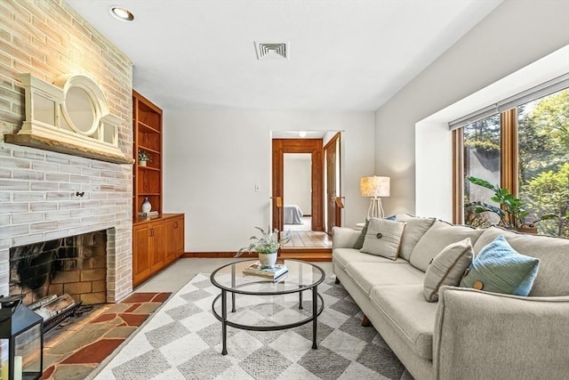22 Grove Pl Unit 4, Winchester, MA 01890 - living area featuring built in shelves, baseboards, a brick fireplace, and recessed lighting