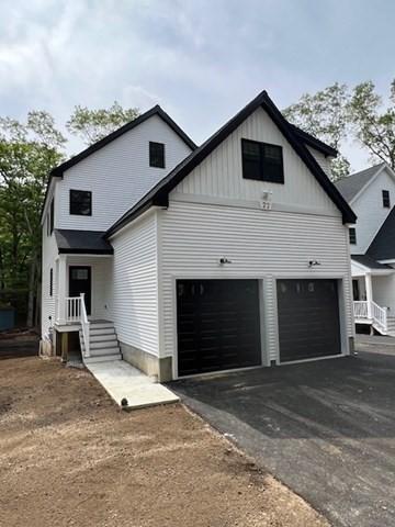 24 Cooper Rd, Webster, MA 01570 - view of front of property with driveway, a garage, and board and batten siding