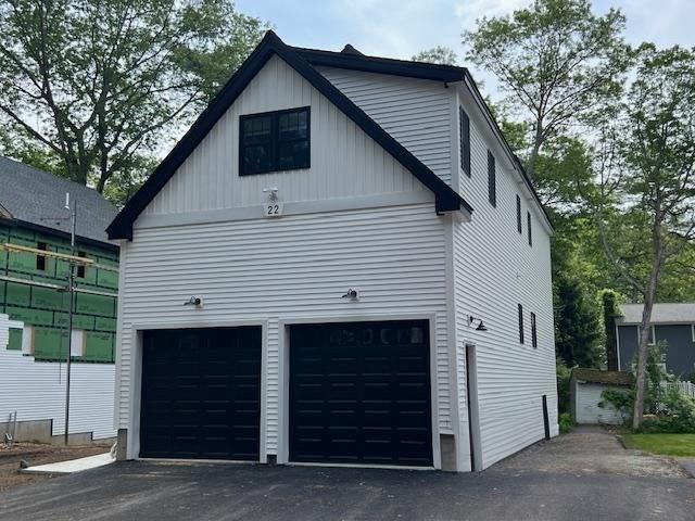 24 Cooper Rd, Webster, MA 01570 - view of property exterior with a garage and board and batten siding